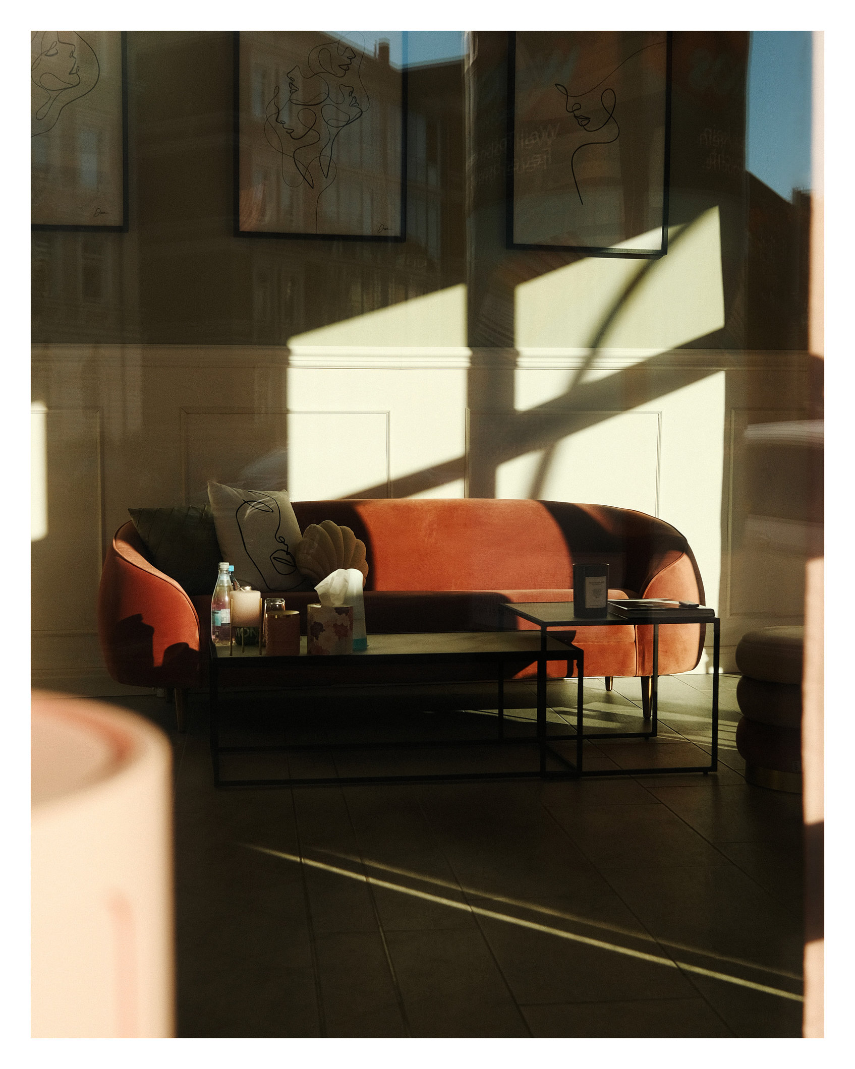 Roter Sessel hinter Schaufenster mit Lichtflecken und Spiegelungen